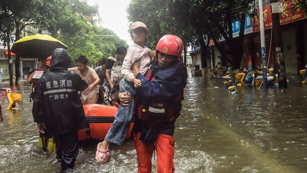 China struggles with twin disasters as storms and landslide claim dozens