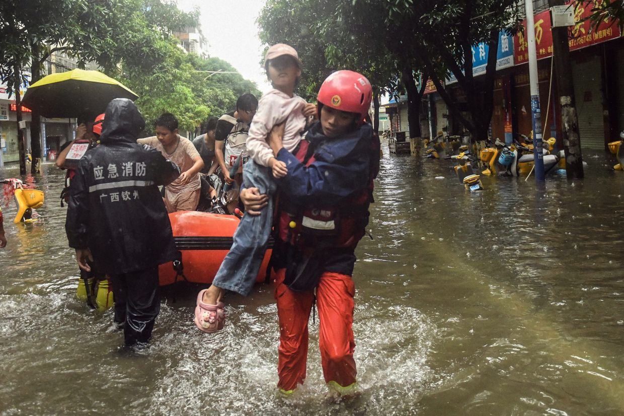 China struggles with twin disasters as storms and landslide claim dozens