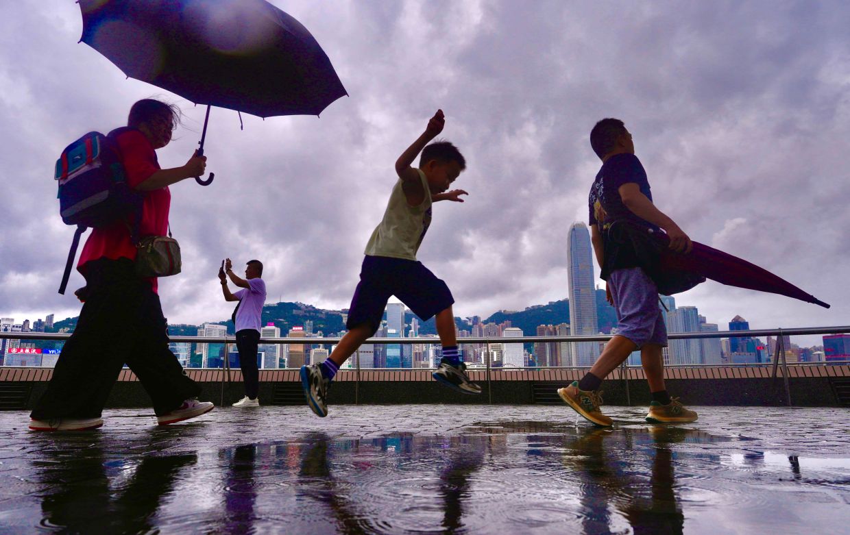 Rain breaks Hong Kong's oppressive heat wave as temperatures ease after record-setting surge